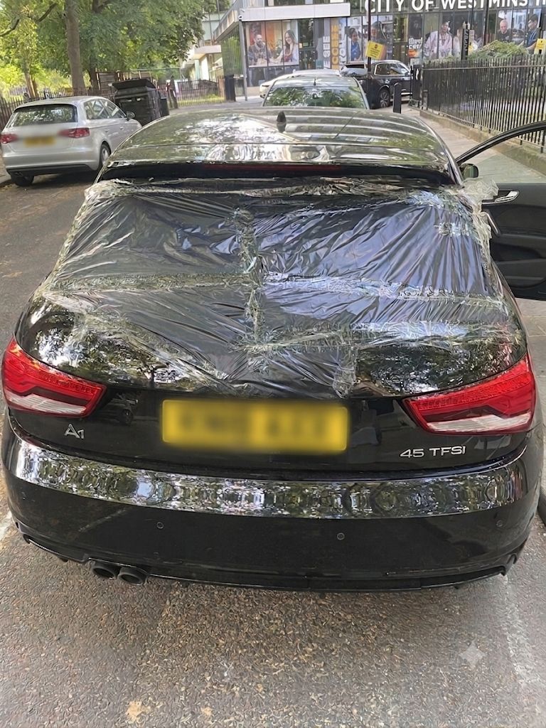 Audi A1 rear windscreen covered in protective plastic sheeting before glass replacement